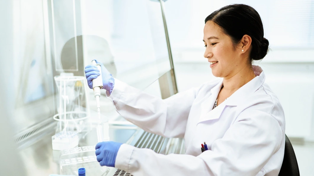 Researcher working in her lab, smiling